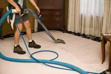 Eye-level view of a professional cleaner using a carpet cleaning machine