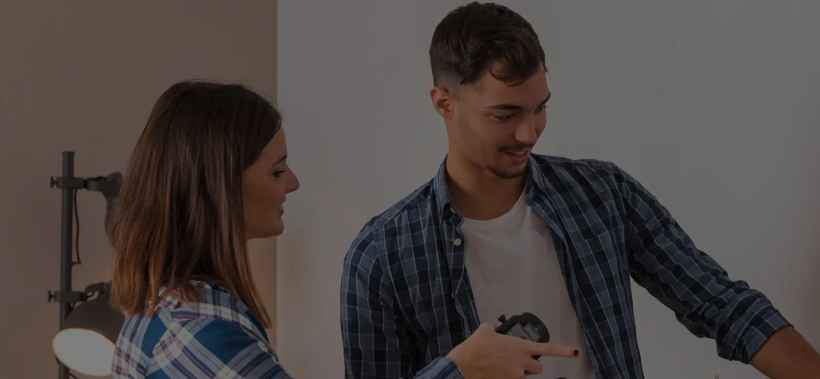 Man and woman looking at photo camera