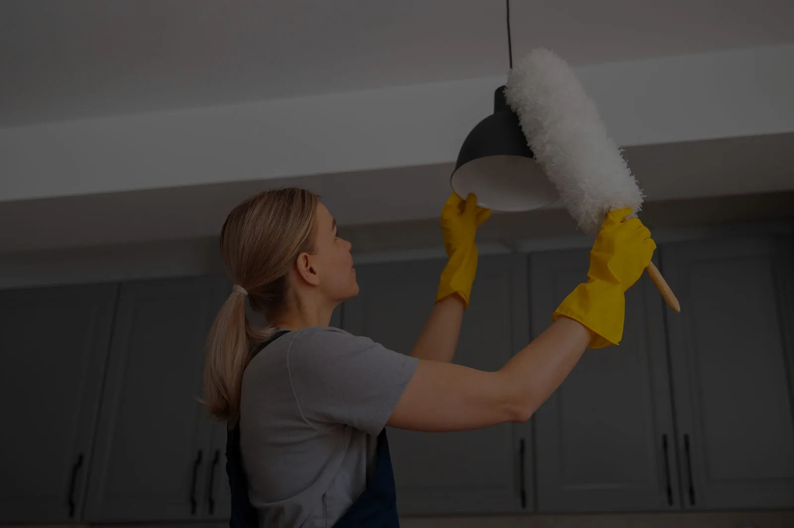 Woman cleaning pendant light